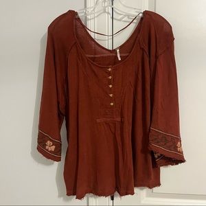 Free people top size small, distressed seams, embroidered sleeve detail